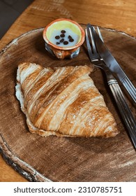 Fresh homemade baked goods include croissants and breads and fresh butter on plate. - Shutterstock ID 2310785751
