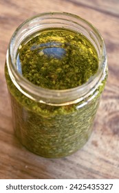 fresh homemade basil pesto placed in a glass jar