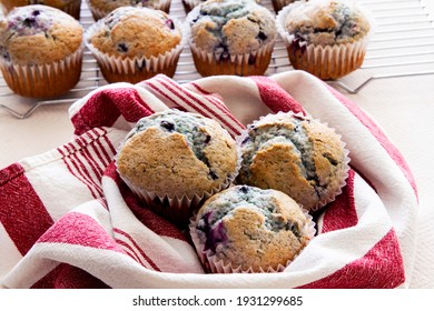 Fresh Homemade Blueberry Muffins Fresh Out Of The Oven; Golden Blueberry Muffins Placed On A Tea Towel And Cooling Racks