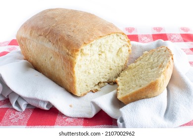 Fresh Homemade Bread End View With Heel Slice Cut Off On Red And White Gingham Tablecloth