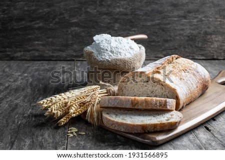 Fresh  homemade bread and flour in small burlap bag 