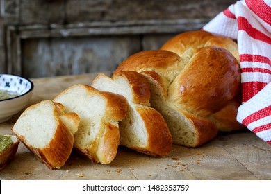 Fresh homemade challah bread. wooden background - horizontal image