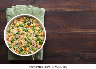 Fresh Homemade Cooked White Quinoa With Colorful Vegetables (green Peas, Sweet Corn Kernels, Green Beans, Carrots) And Parsley In Bowl, Photographed Overhead With Copy Space On The Right Side