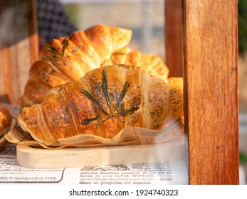 Fresh Homemade Croissant With Cannabis Leaf In The Bakery Display Cabinet. Healthy Fresh Pastry With Marijuana Leaf. Food Concept.