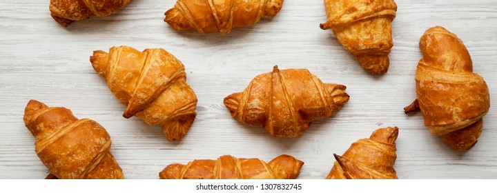 Fresh Homemade Croissants On White Wooden Table, Top View. From Above, Overhead.