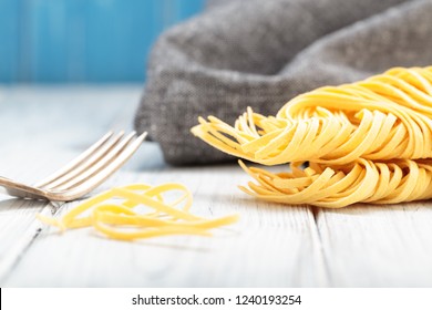 Fresh homemade egg noodles. Italian pasta with fork. - Shutterstock ID 1240193254