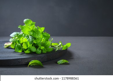 Fresh homemade green peppermint on a gray dark concrete table. Green mint. Spearmint.