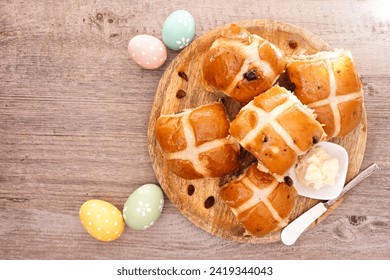 Fresh homemade Hot Cross Buns on a wooden plate. Above view table scene on a wood background. Easter food concept. - Powered by Shutterstock