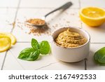 Fresh homemade organic dijon mustard in a bowl on white background, close up