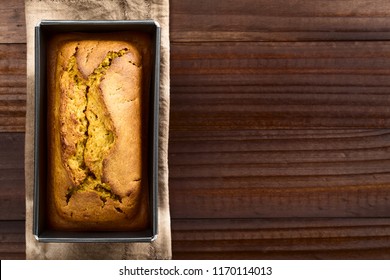 Fresh Homemade Pumpkin Bread In Pan, Photographed Overhead With Copy Space On The Side (Selective Focus, Focus On The Top Of The Bread)