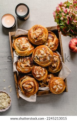 Fresh Homemade Rolls Buns with apples and cinnamon in glaze on a table with natural linen tablecloth. Top view flat lay background.