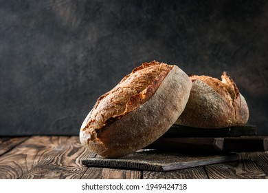 Fresh homemade sourdough bread on a rustic background with copy space.