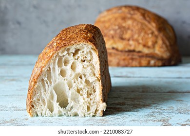 Fresh homemade sourdough bread with whole grain flour on a gray-blue background. Healthy food. - Shutterstock ID 2210083727
