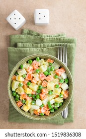 Fresh Homemade Vegetarian Russian Or Olivier Salad Made Of Potato, Carrot, Pea, Hard-boiled Egg And A Mayonnaise Dressing, Served In Bowl, Photographed Overhead (Selective Focus, Focus On The Salad) 