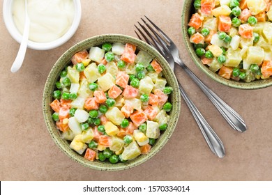 Fresh Homemade Vegetarian Russian Or Olivier Salad Made Of Potato, Carrot, Pea, Hard-boiled Egg And A Mayonnaise Dressing, Photographed Overhead (Selective Focus, Focus On The Salad) 