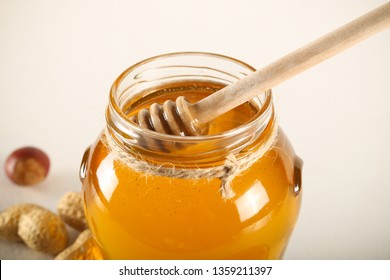 fresh honey stands on a white background - Powered by Shutterstock