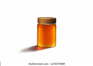 Fresh honey with wooden lid on a glass container. Following center dominant law in white paper background.