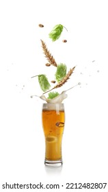 Fresh Hops Flowers With Leaves And Wheat Grains Falling Into Glass Of Beer On White Background