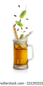 Fresh Hops Flowers With Leaves And Wheat Grains Falling Into Glass Mug Of Beer On White Background