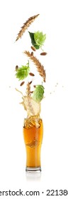 Fresh Hops Flowers With Leaves And Wheat Grains Falling Into Glass Of Beer On White Background