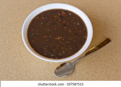 Fresh Hot Black Bean Soup In White Bowl On Kitchen Table