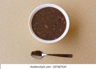 Fresh Hot Black Bean Soup In White Bowl On Kitchen Table