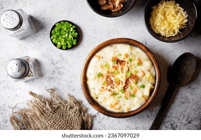 Fresh hot chowder soup with fried bacon slices and shredded cheese in a bowl. toning - Shutterstock ID 2367097029