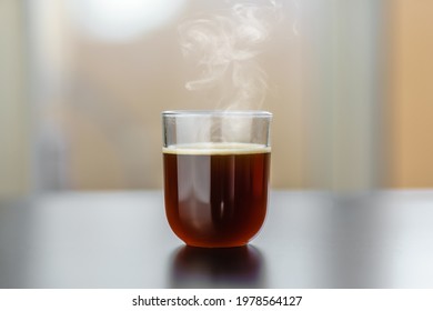 Fresh hot french pressed, filtered coffee in a minimalist glass in the afternoon. Home prepared during Covid-19 pandemic. Perfect for print and copy