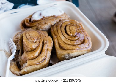 Fresh And Hot Large Cinnamon Rolls In A To Go Box From A Bakery.