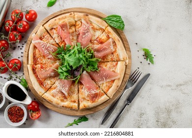 Fresh Hot Pizza With A Ham On The Concrete Background