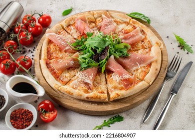 Fresh Hot Pizza With A Ham On The Concrete Background