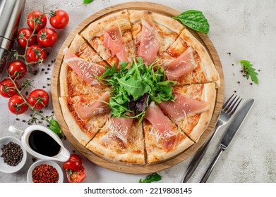 Fresh Hot Pizza With A Ham On The Concrete Background