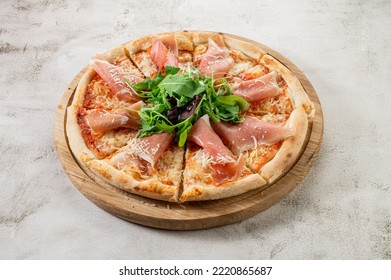 Fresh Hot Pizza With A Ham On The Concrete Background