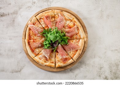 Fresh Hot Pizza With A Ham On The Concrete Background