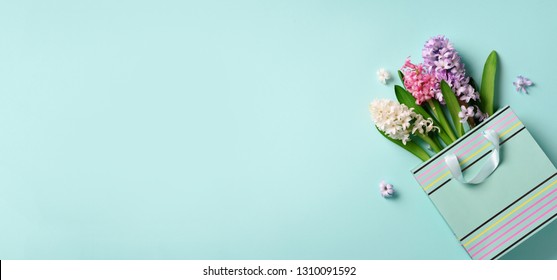 Fresh Hyacinth Flowers In Shopping Bag On Blue Punchy Pastel Background. Banner With Copy Space. Spring, Summer, Woman Day Concept. Creative Layout. Top View, Flat Lay