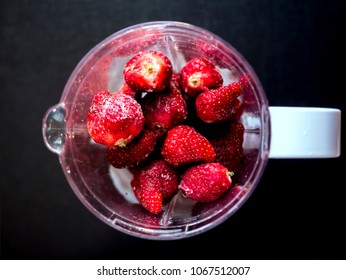 Fresh Iced Juicy Strawberries In Blender Top Down View On Dark Surface