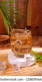 Fresh Iced Tea In A Round Glass. With Ice Dropped From Above.