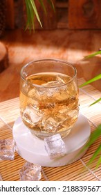 Fresh Iced Tea In A Round Glass. With Ice Dropped From Above.