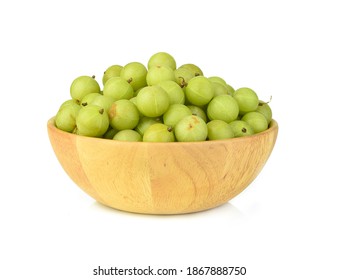 Fresh Indian gooseberry fruits in wooden bowl on white background.