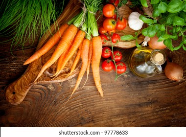 Fresh ingredients for cooking in rustic setting: tomatoes, basil, olive oil, garlic and onion - Powered by Shutterstock