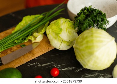 Fresh ingredients, including lettuce, cherry tomatoes, and green herbs, neatly placed on a wooden cutting board with a kitchen knife.
A colorful arrangement of vegetables on a dark marble countertop,  - Powered by Shutterstock