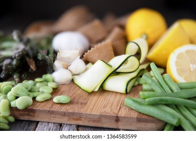 Fresh ingredients for pasta, zucchini, lima beans, green beans, lemon, garlic and homemade whole wheat pappardelle pasta. - Powered by Shutterstock