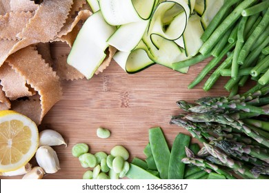 Fresh ingredients for pasta, zucchini, lima beans, green beans, lemon, garlic and homemade whole wheat pappardelle pasta. Flat lay with copy space in center. - Powered by Shutterstock