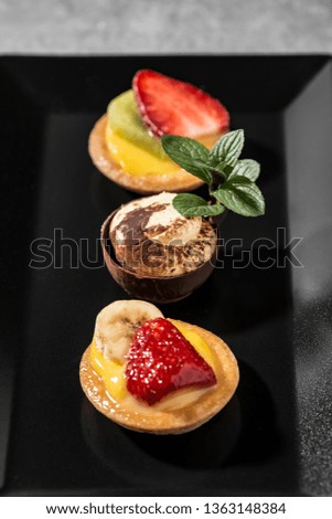 Similar – Image, Stock Photo Assorted gourmet pastries with fresh fruit toppings