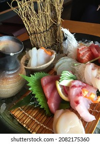 Fresh Japanese raw fish sashimi りようりrestaurant with tuna, squid and salmon dipped in soy sauce with wasabi