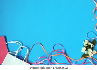 Fresh jasmine flowers, ribbons, gift bags on a blue bright background, for romantic greetings, top view, copy space - Shutterstock ID 1752658592
