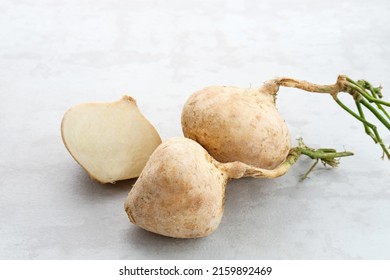 Fresh Jicama or bengkoang, white tubers that can be eaten as salad or for face masks. Isolated on grey background. Prebiotic food, gut health.
