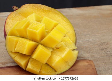 Fresh juicy cutting mango on a wooden table. Shallow depth of field