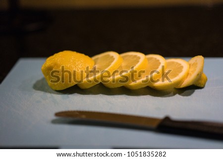 Fresh juicy lemon. Slice thin slices on a cutting board