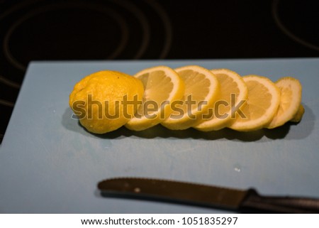 Fresh juicy lemon. Slice thin slices on a cutting board